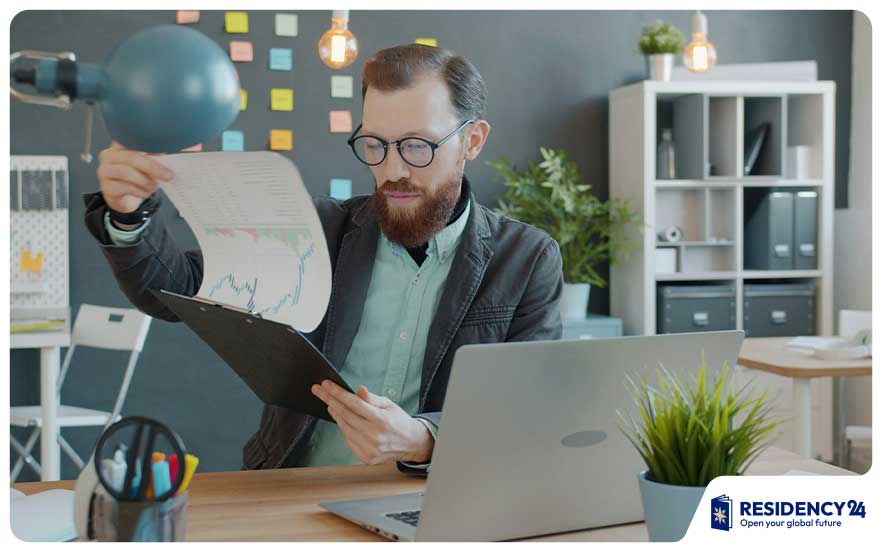 thinking reviewing documents office desk person